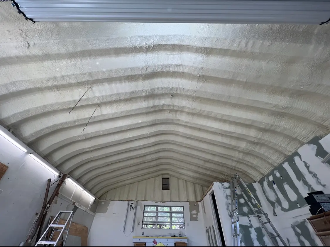 Spray polyurethane foam applied to the underside of a metal roof deck in Lockhart